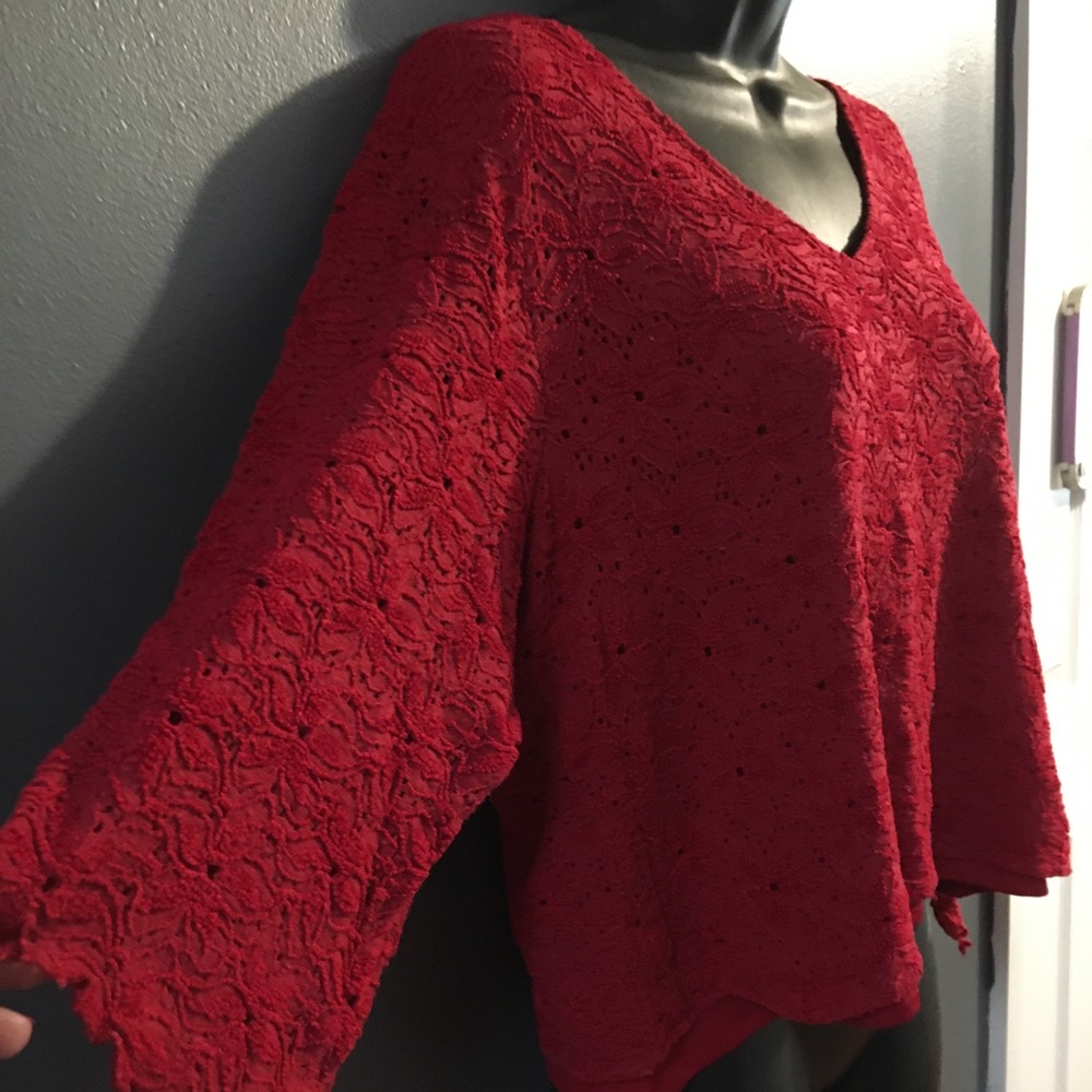 Woman’s red lace over red top with butterfly sleeves